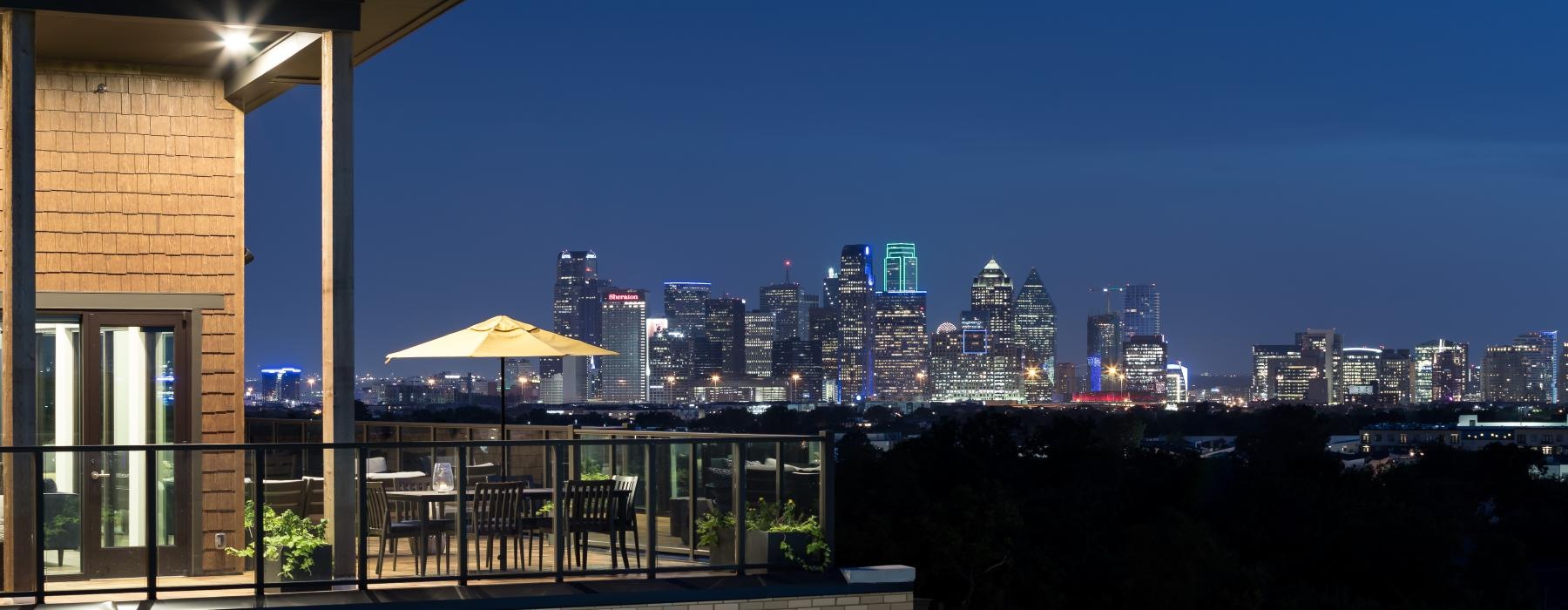 a view of a city from a balcony at night