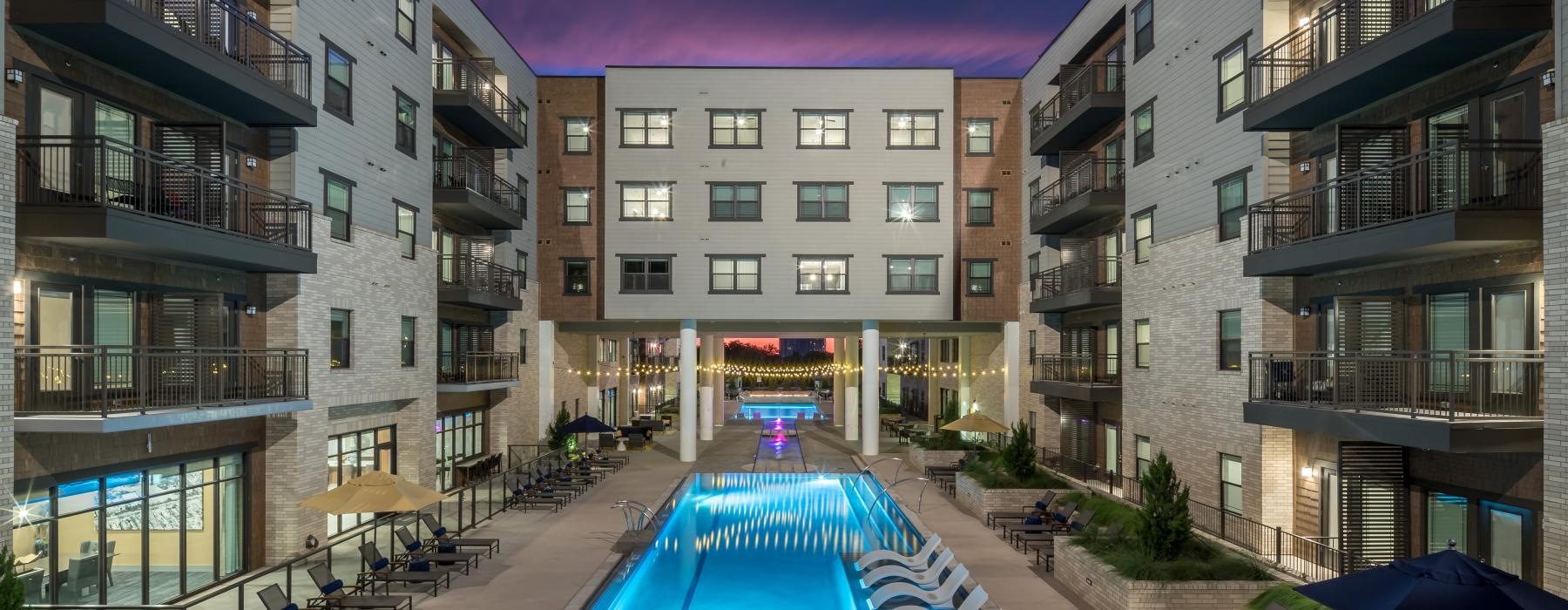 a pool in a courtyard between buildings